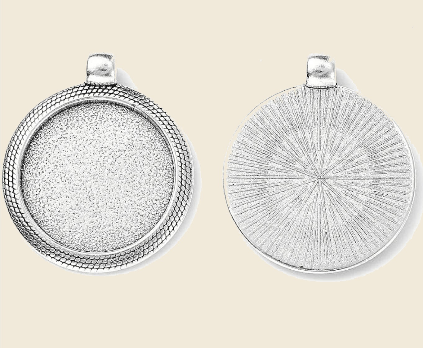 Front and back view of silver-tone bezel pendant on warm beige background
