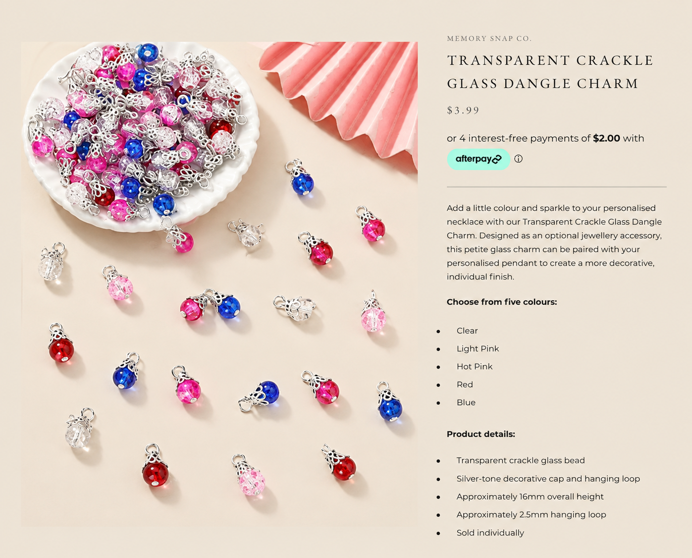Transparent crackle glass dangle charms in clear, light pink, hot pink, red and blue on a professional beige product background
